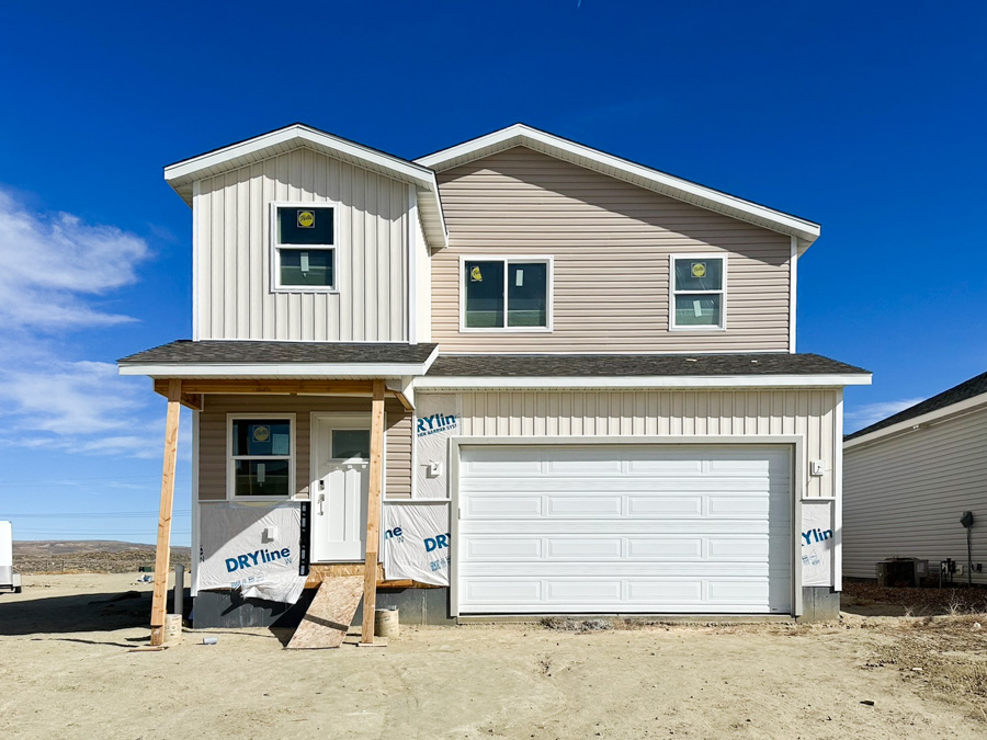  Lindbergh model, depicting a two-story home with a modern exterior, a front porch, a two-car garage, and a well-maintained landscape with grass.